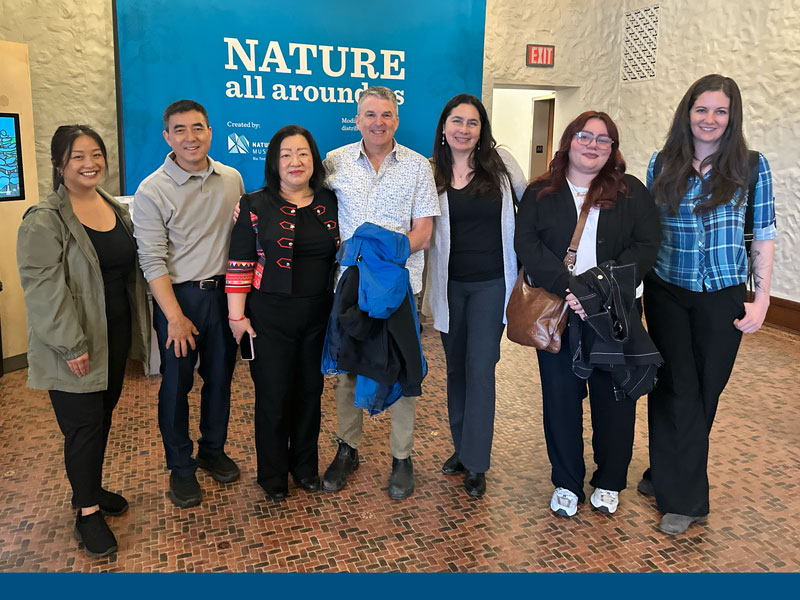 group of people smiling and looking at the camera