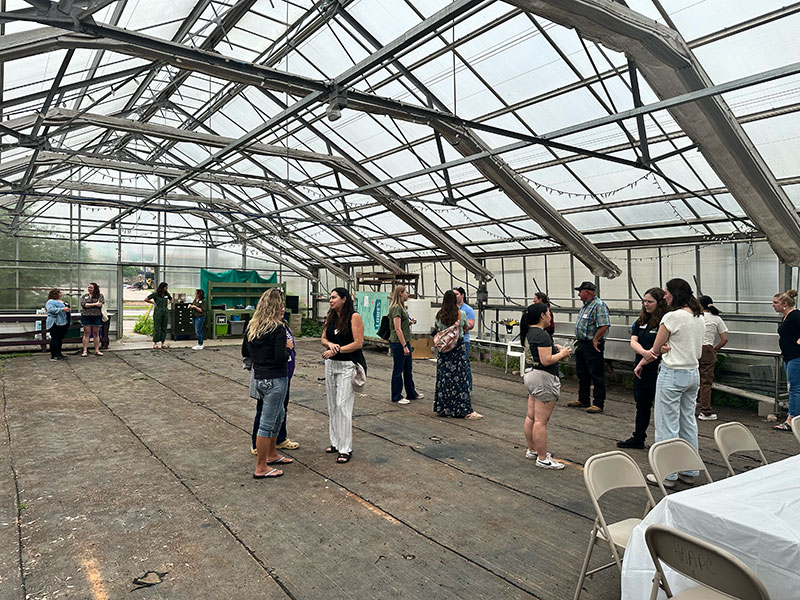 people in a large greenhouse