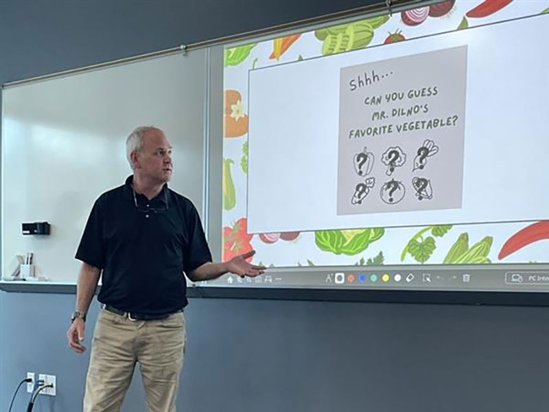 A teacher presenting a slide to a class