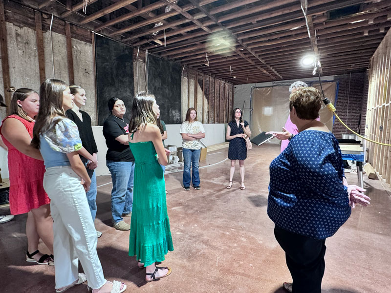 group of people standing in under-construction space